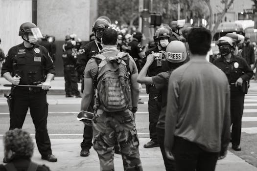 Black and white photo of protesters and police in Los Angeles during a rally.